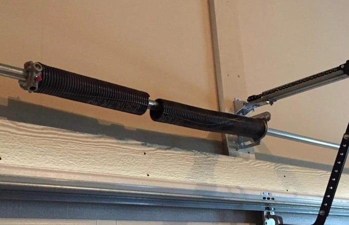 Broken Garage Door Spring Repaired By Strongman Garage Doors In Tomball Texas ensuring reliable and safe garage door operation for residential customers